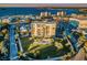 Stunning aerial view of a luxury condominium building overlooking the city and waterfront with pool at 2530 Gary Cir # 401, Dunedin, FL 34698