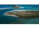 Magnificent aerial shot of a pristine island with turquoise waters and lush greenery at 2530 Gary Cir # 401, Dunedin, FL 34698