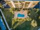 Bird's-eye view showcases community's manicured grounds, pool, landscaping, parking, with nearby street at 2530 Gary Cir # 401, Dunedin, FL 34698