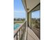 A long balcony overlooks the community pool and offers views of the bay beyond at 2530 Gary Cir # 401, Dunedin, FL 34698