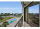 Balcony offers scenic views of the pool and ocean with a railing, sliding glass doors and palm trees at 2530 Gary Cir # 401, Dunedin, FL 34698