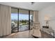 This angle shows the covered balcony with neutral furniture, a ceiling fan, and incredible water views at 2530 Gary Cir # 401, Dunedin, FL 34698