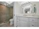 Modern bathroom featuring a glass-enclosed shower and a vanity with lots of storage at 2530 Gary Cir # 401, Dunedin, FL 34698