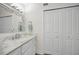 Bathroom featuring marble countertop vanity with chrome fixtures and closet for storage at 2530 Gary Cir # 401, Dunedin, FL 34698