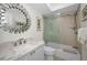 Bathroom showcasing glass shower doors, stone tiling, and a stone countertop vanity at 2530 Gary Cir # 401, Dunedin, FL 34698