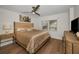 Bedroom features neutral paint, a modern ceiling fan, and natural light from window at 2530 Gary Cir # 401, Dunedin, FL 34698