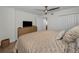 Bright bedroom with closet and side table with hardwood floors and modern ceiling fan at 2530 Gary Cir # 401, Dunedin, FL 34698