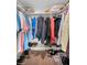 Walk-in closet with hardwood floors, shelving for shoes, and hanging racks for storage at 2530 Gary Cir # 401, Dunedin, FL 34698