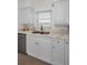 Kitchen area featuring stainless steel appliances and white shaker cabinets at 2530 Gary Cir # 401, Dunedin, FL 34698
