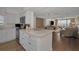 Open-concept kitchen and living area with modern appliances and marble countertops at 2530 Gary Cir # 401, Dunedin, FL 34698
