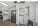 Convenient laundry closet adjacent to the kitchen featuring a full size washer and dryer at 2530 Gary Cir # 401, Dunedin, FL 34698
