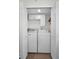 Dedicated laundry closet featuring a Maytag washer and dryer and storage cabinets at 2530 Gary Cir # 401, Dunedin, FL 34698