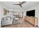 Living room with a gray sofa, wood floors, modern decor, and a ceiling fan showcases contemporary style at 2530 Gary Cir # 401, Dunedin, FL 34698