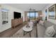 Relax in the light-filled living room with access to the outdoor balcony and gorgeous views at 2530 Gary Cir # 401, Dunedin, FL 34698