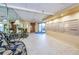 View of the condo building lobby with seating, tile floors, mirrors and mailboxes at 2530 Gary Cir # 401, Dunedin, FL 34698