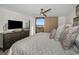 Comfortable main bedroom features a TV, ceiling fan, and direct access to a large window at 2530 Gary Cir # 401, Dunedin, FL 34698
