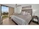 Comfortable main bedroom with a view, a ceiling fan, and stylish furnishings at 2530 Gary Cir # 401, Dunedin, FL 34698