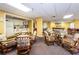 Inviting recreation room furnished with comfortable seating arrangements, an adjacent kitchen and billiard table at 2530 Gary Cir # 401, Dunedin, FL 34698