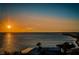 Beautiful sunset view with a beach, homes, and a body of water at 2530 Gary Cir # 401, Dunedin, FL 34698