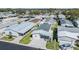 Overhead shot capturing the well-maintained home, attached carport, and vibrant landscaping in an established neighborhood at 3110 Moss Hill St, Wesley Chapel, FL 33543