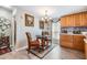 Cozy dining area features a chandelier, table with chairs, and natural light at 3110 Moss Hill St, Wesley Chapel, FL 33543