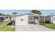 Charming home with a covered carport and well-maintained lawn, perfect for enjoying outdoor living at 3110 Moss Hill St, Wesley Chapel, FL 33543