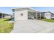 Charming home with a covered carport and well-maintained lawn, perfect for enjoying outdoor living at 3110 Moss Hill St, Wesley Chapel, FL 33543