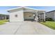 Charming home with a covered carport and well-maintained lawn, perfect for enjoying outdoor living at 3110 Moss Hill St, Wesley Chapel, FL 33543