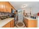 Charming kitchen with wood cabinets, stainless appliances, and decorative backsplash at 3110 Moss Hill St, Wesley Chapel, FL 33543