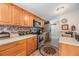 Modern kitchen with wood cabinets and stainless steel appliances at 3110 Moss Hill St, Wesley Chapel, FL 33543