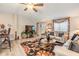 Cozy living room with a ceiling fan, stylish rug, and comfortable seating for relaxing or entertaining at 3110 Moss Hill St, Wesley Chapel, FL 33543