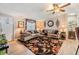 Cozy living room boasts wood-look flooring, and large windows for natural light at 3110 Moss Hill St, Wesley Chapel, FL 33543