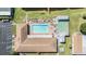 Overhead view showcasing the sparkling pool, shuffleboard court, and recreation area amenities for community enjoyment at 3110 Moss Hill St, Wesley Chapel, FL 33543
