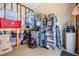 Storage room features ample shelving, plastic storage bins, and carpeted flooring at 3110 Moss Hill St, Wesley Chapel, FL 33543