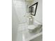 Cozy bathroom features white cabinets, a toilet and a mirror at 3300 Fox Chase N Cir # 229, Palm Harbor, FL 34683