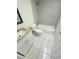 Bathroom featuring a white vanity with a marble countertop, toilet, and tiled shower at 3300 Fox Chase N Cir # 229, Palm Harbor, FL 34683