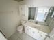 Bathroom featuring a vanity, sink, toilet, and mirror at 3300 Fox Chase N Cir # 229, Palm Harbor, FL 34683