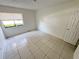 A clean bedroom features a window with great natural light and neutral paint at 3300 Fox Chase N Cir # 229, Palm Harbor, FL 34683