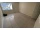 Empty bedroom with tile floor, white door and neutral paint, offering a blank canvas for personalization at 3300 Fox Chase N Cir # 229, Palm Harbor, FL 34683