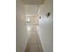 Bright hallway leads to rooms with tile flooring throughout at 3300 Fox Chase N Cir # 229, Palm Harbor, FL 34683