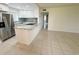 This kitchen features white cabinets, stone countertops and stainless steel appliances at 3300 Fox Chase N Cir # 229, Palm Harbor, FL 34683