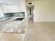 This modern kitchen features white cabinets, stone countertops, and stainless steel appliances at 3300 Fox Chase N Cir # 229, Palm Harbor, FL 34683