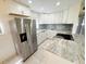Modern kitchen featuring stainless steel appliances, beautiful countertops, and white cabinets at 3300 Fox Chase N Cir # 229, Palm Harbor, FL 34683