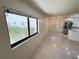 View of the living space, showcasing the floor tile, lighting, and natural light from the window at 3300 Fox Chase N Cir # 229, Palm Harbor, FL 34683