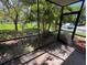 View from the screened in lanai shows a beautiful manicured lawn at 3300 Fox Chase N Cir # 229, Palm Harbor, FL 34683