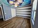 bedroom with unique soccer ball ceiling design, hardwood floors, modern ceiling fan and a large window at 3367 Janna Grace Way, Land O Lakes, FL 34638