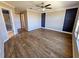 View of a spacious bedroom with hardwood floors, a modern ceiling fan, and ample natural light at 3367 Janna Grace Way, Land O Lakes, FL 34638