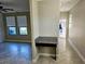 Hallway view with granite desk nook and entry door at 3367 Janna Grace Way, Land O Lakes, FL 34638