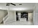 Open-concept living space with modern kitchen, stainless steel appliances, and staircase at 3367 Janna Grace Way, Land O Lakes, FL 34638