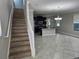 Open concept view from staircase to living room, with kitchen in the background at 3367 Janna Grace Way, Land O Lakes, FL 34638
